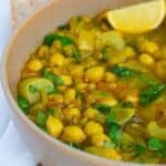 Moroccan Harira Soup in a brown bowl with a lemon