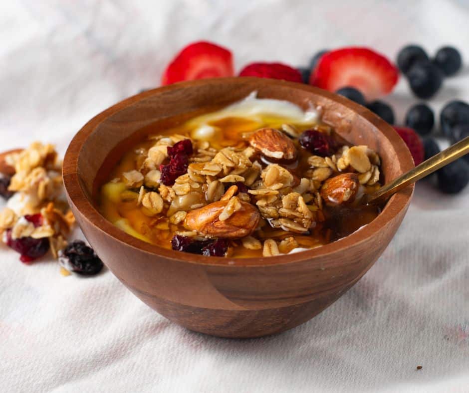 Almond-Cranberry-Granola in a brown bowl with Greek yogurt