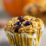 A close up of a pumpkin muffin with oats and chocolate chip