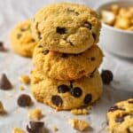 Cashew butter cookies with chocolate chips stacked three high.