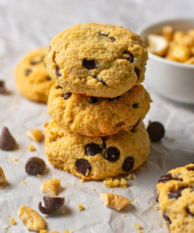 Cashew butter cookies with chocolate chips stacked three high.