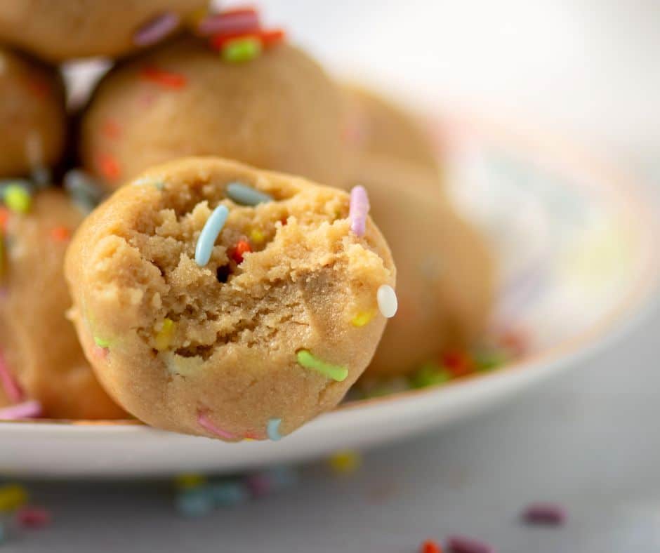 Close-up of a cake batter protein ball with colorful sprinkles