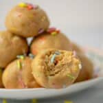 Close-up of a cake batter protein ball with colorful sprinkles