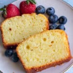 Moist easy vanilla protein cake sliced and served with fresh berries on a plate