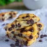 3 Chocolate Chip Protein Scones in a pile on a white paper