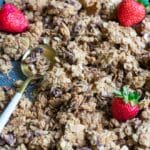 Healthy Cookie Granola Clusters with strawberries on a baking pan