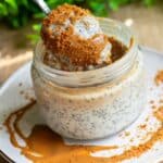 A spoon digging into High-Protein Biscoff Chia Pudding in a jar