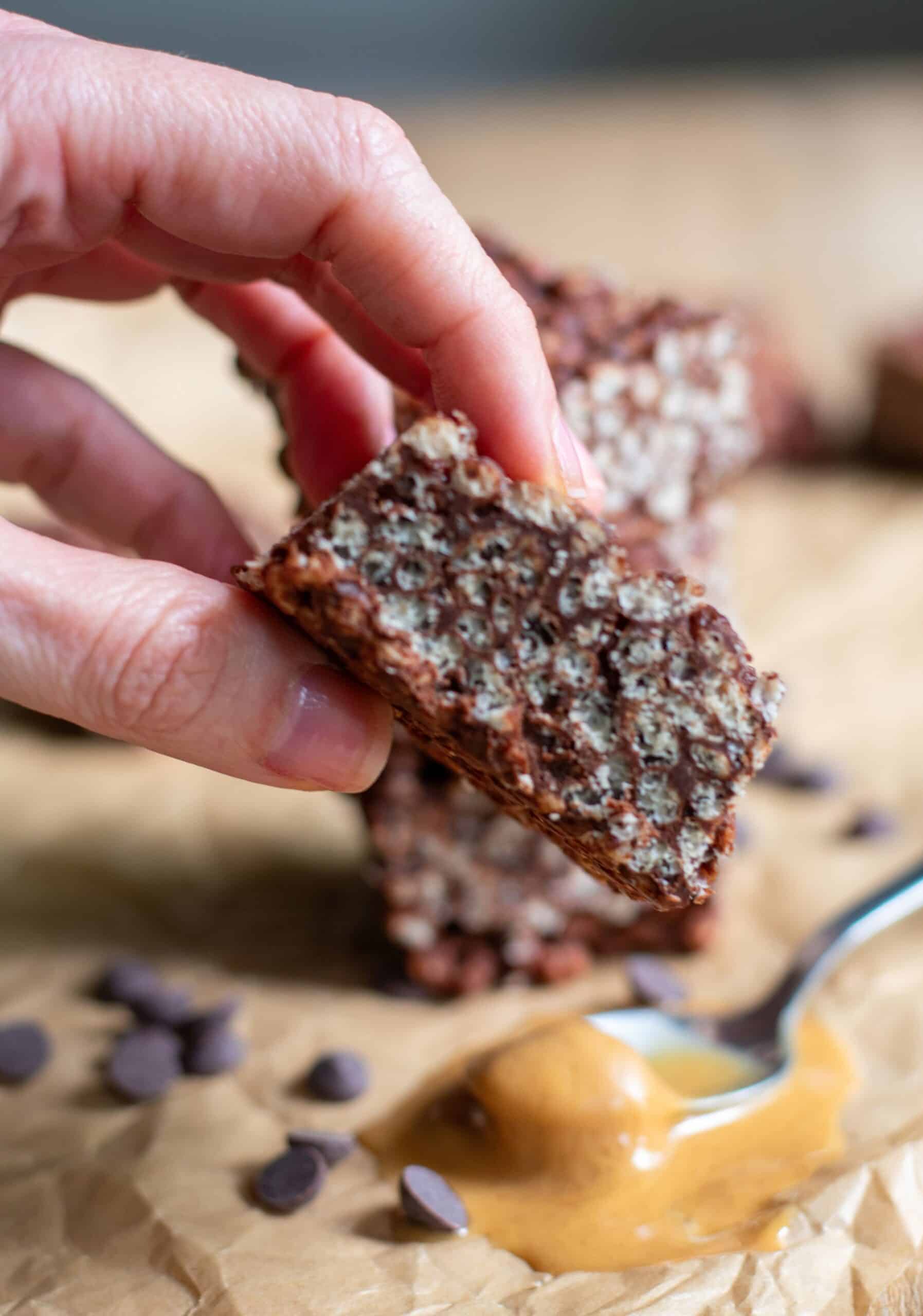 A hand holding a Chocolate Peanut Butter Crispy Bar